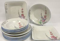 Set of Shelley bone china dishes with floral pattern including square and round bowls and plates stacked.