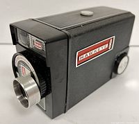 Side angle photo of the Kodak Hawkeye 8mm film camera showing the Kodak logo, lens mount, and control dial