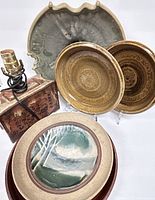 Group photo showing pottery lamp base with electrical cord plus four diverse pottery platters of different sizes and glazes.