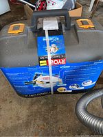 Image showing the Ryobi carrying case with product label and packaging tape intact on case handle