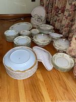 Full assortment of Noritake dinnerware displayed on hardwood floor