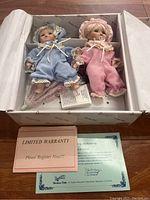 Pair of Duck House Heirloom Dolls in original box with certificate and limited warranty card.