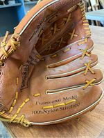 Close-up of inner palm area displaying 'Professional Model 100% Nylon Stitched' and part of glove interior showing leather, lacing, and finger cross stitching