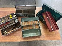 All four boxes displayed, showing open compartments and tools inside one box