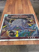 Full view of the Fire Power pinball backglass showing spaceship flying past a planet with explosions and score display areas.