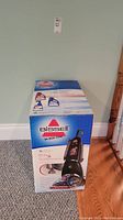 Front view of sealed Bissell ProHeat 2X box against wall and floor