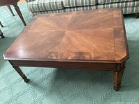 Top view of mahogany coffee table showing quadrant inlay pattern and some water marks.
