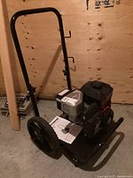 Full view of generator on frame with wheels and folding handle