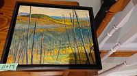 Full view of the oil painting in black wood frame depicting forest landscape with charred trees and hills