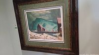 Overall view of framed and matted print leaning against wall