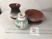Three Southwest style pottery items: two vases and one planter pot shown with ruler for size reference.