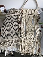 Photo of two vintage textiles, one macrame wall hanging with wooden beads, one woven textile with checker pattern.
