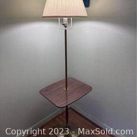 Full view of the mercury lamp table assembled and standing in the corner, showing wood grain square tabletop, brass lamp pole, and pleated beige lampshade.