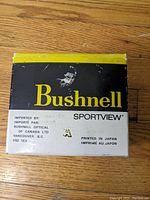 Box showing Bushnell Sportview branding with importer info and 'Printed in Japan'.
