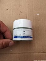 Handheld jar of Cellex-C Enhancer Sea Silk Oil-Free Moisturizer showing label and size of 30 ml.