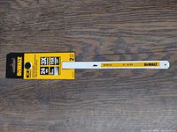 Photo of two new Dewalt 10-inch bi-metal hacksaw blades in yellow-black packaging showing blade specifications: 24 TPI, 3X sharper, 15X longer, 2 blades in pack.