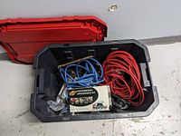 Open Husky tote showing contents inside including two extension cords and appearance kit