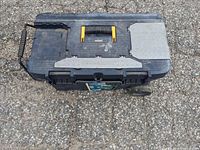 Closed black Mastercraft toolbox showing wheels and handle, with some wear marks on surface.