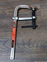 Each photo shows a single TASK brand metalworking clamp, 8 inch, new condition, metal with black handle and orange and black label.