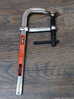 Close-up photo of a single 8 inch metal working clamp, showing brand label and screw mechanism