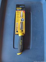 Photo showing full Stanley FatMax jab saw in original packaging with yellow and black handle and serrated blade