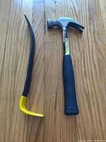 Photo of Stanley Wonderbar pry bar next to Fuller hammer on wood floor, showing item details and condition