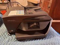 Photo showing entire HP OfficeJet Pro 6968 printer from angled top view, displaying the automatic document feeder and front panel.