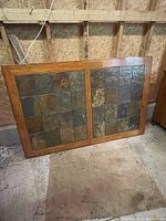 Close-up of table top showing wood frame with tile inlay squares