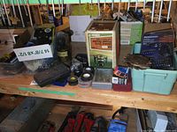 Various tools and accessories including boxed Craftsman router, dado blades, hardware, and storage boxes on wooden workbench.