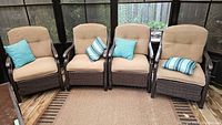 Front view of all four chairs arranged side by side with cushions and pillows.