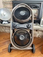 Front view of the Honeywell dual fan showing two circular fans in a vertical frame and dual control knobs.