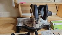 Black & Decker power miter saw showing the base and angle markings, partially viewed from the side.