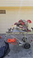Front view of saw mounted on stand with power cord coiled below