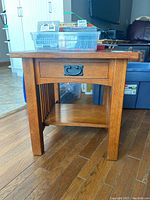 Side view showing drawer, slatted sides, lower shelf, and overall construction.