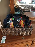Basket containing 20 Star Wars action figures still sealed in packaging with black card backs featuring Darth Vader's helmet and the Power of the Force logo.