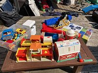 Overview of vintage Fisher Price toys including farm set pieces, horse ride-on, and various vehicles and figures.