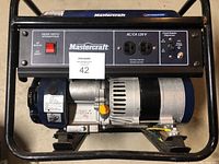 Top-down view of the generator showing engine switch, outlets, circuit breaker, and Mastercraft branding.