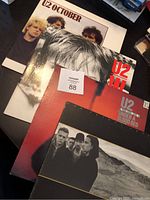 Group photo of four U2 vinyl albums showing cover art of October, WAR, Live Under a Blood Red Sky, and Joshua Tree.