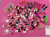 Wide overhead of entire shoe collection on pink backdrop