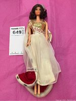 Full body view of the 1966 Miss America Barbie doll showing the gold metallic top, white skirt, Miss America sash, and red velvet cape with faux fur trim.