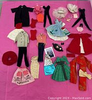 Full view of all clothing and accessories displayed on pink background