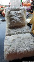 Fuzzy chair with matching fuzzy throw pillow and fuzzy ottoman arranged together, showing fabric texture and overall size.