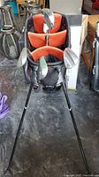 Photo of the golf bag top with clubs inserted, showing the club heads and orange interior dividers.