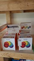 Eight boxes on shelf: seven appetizer plate boxes and one espresso mug box