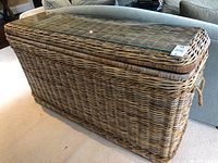 Front-side view of wicker console table showing basket weave and glass top