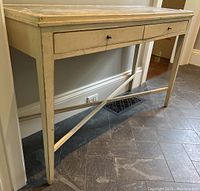Front view of the console table showing overall structure, drawer placement and leg design