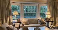 Pair of glazed linen panels hung in living room window setting