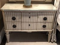 Front elevation of painted two-drawer commode with glass top and lamp