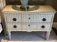 Front view of white fluted bedside commode with two drawers and glass top