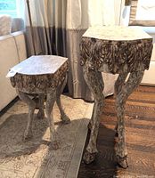 Pair of side tables displayed together showing relative sizes, shapes, and finish